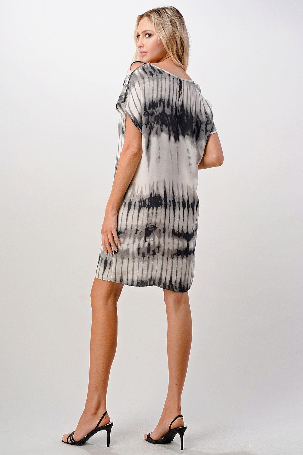 A stylish short sleeve tie-dye shift dress displayed on a model, showcasing its vibrant colors and relaxed fit.