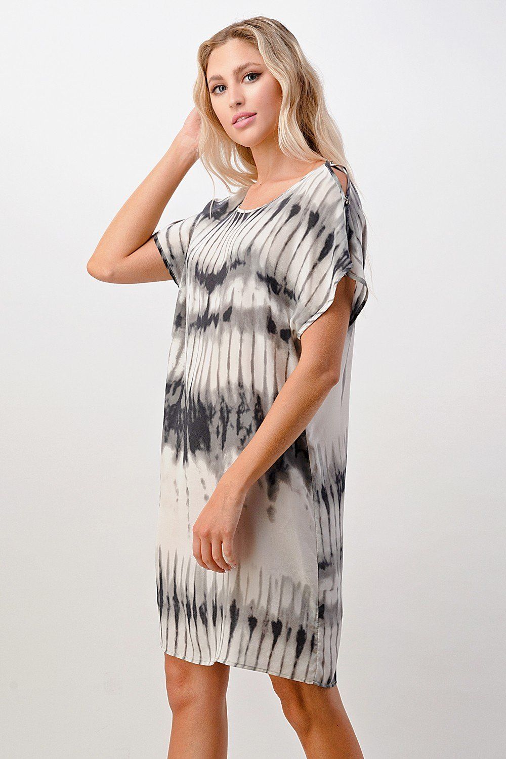 A stylish short sleeve tie-dye shift dress displayed on a model, showcasing its vibrant colors and relaxed fit.