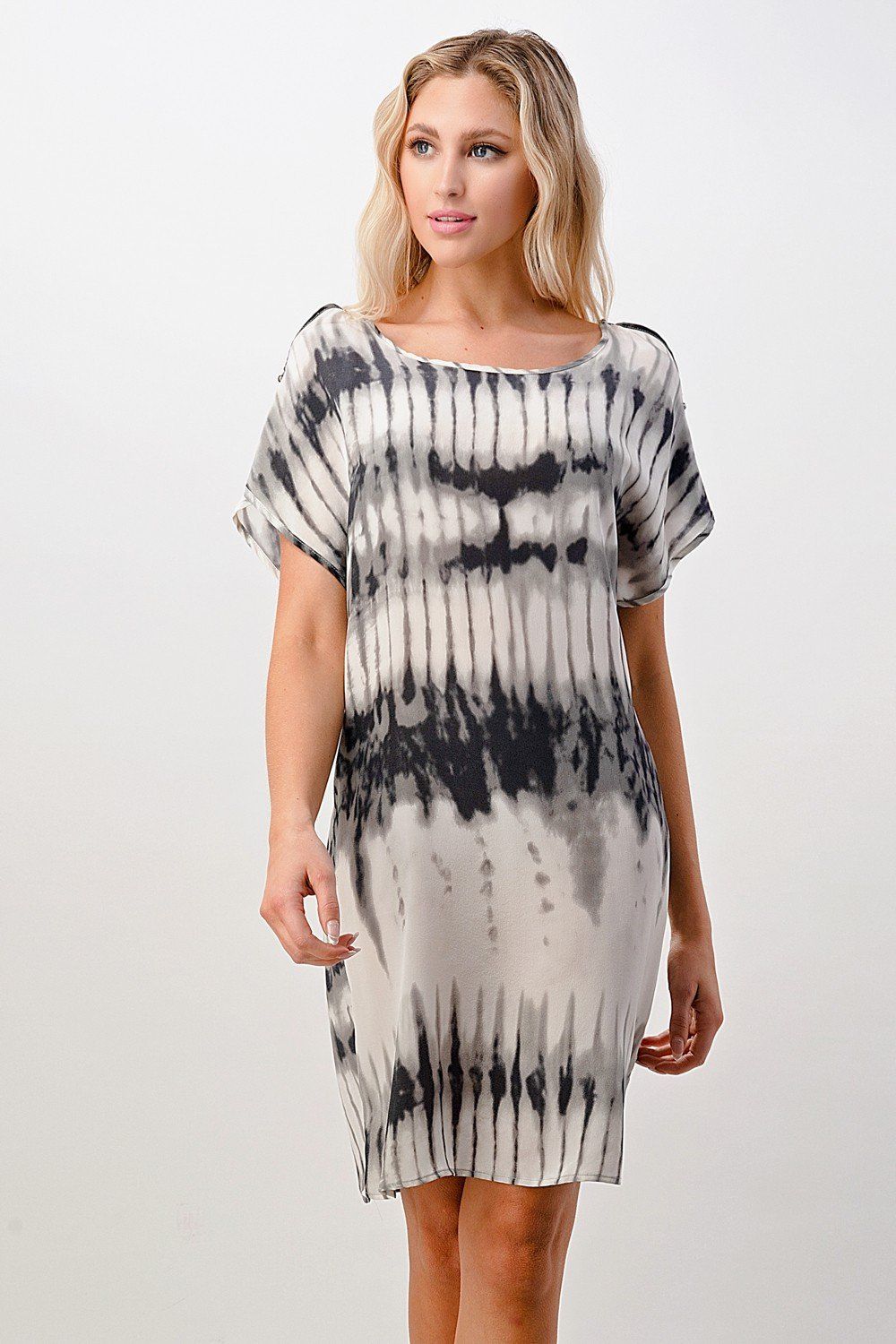 A stylish short sleeve tie-dye shift dress displayed on a model, showcasing its vibrant colors and relaxed fit.