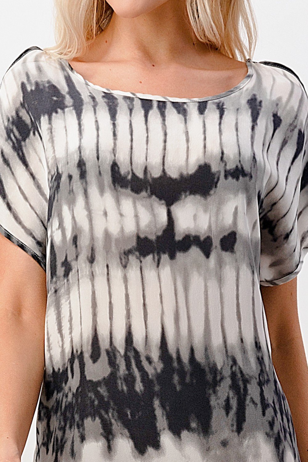 A stylish short sleeve tie-dye shift dress displayed on a model, showcasing its vibrant colors and relaxed fit.