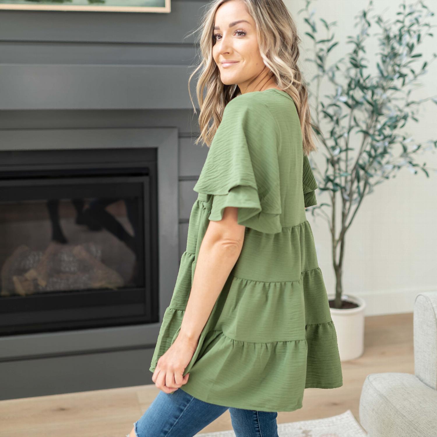 A stylish short sleeve tiered dress in light gray, featuring ruffled tiers and a slight V-neckline, perfect for spring and summer occasions.