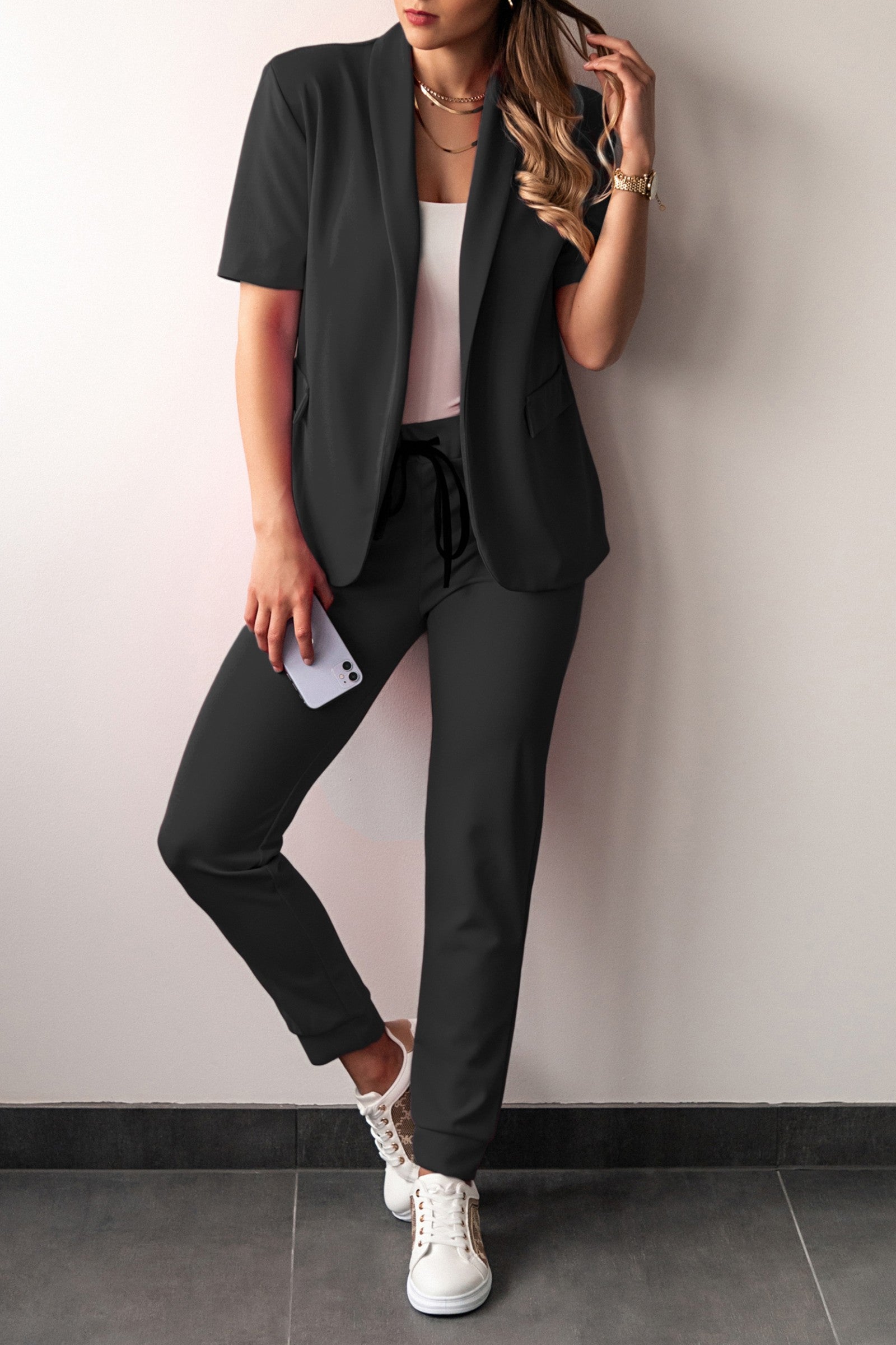 Elegant black short-sleeved blazer and fitted pants set, showcasing classic collar and drawstring waist.