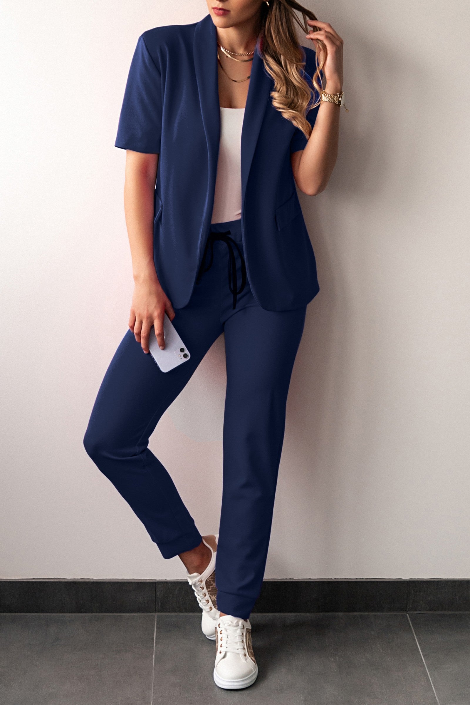 Elegant dark blue short-sleeved blazer and fitted pants set, showcasing Italian craftsmanship and stylish design.