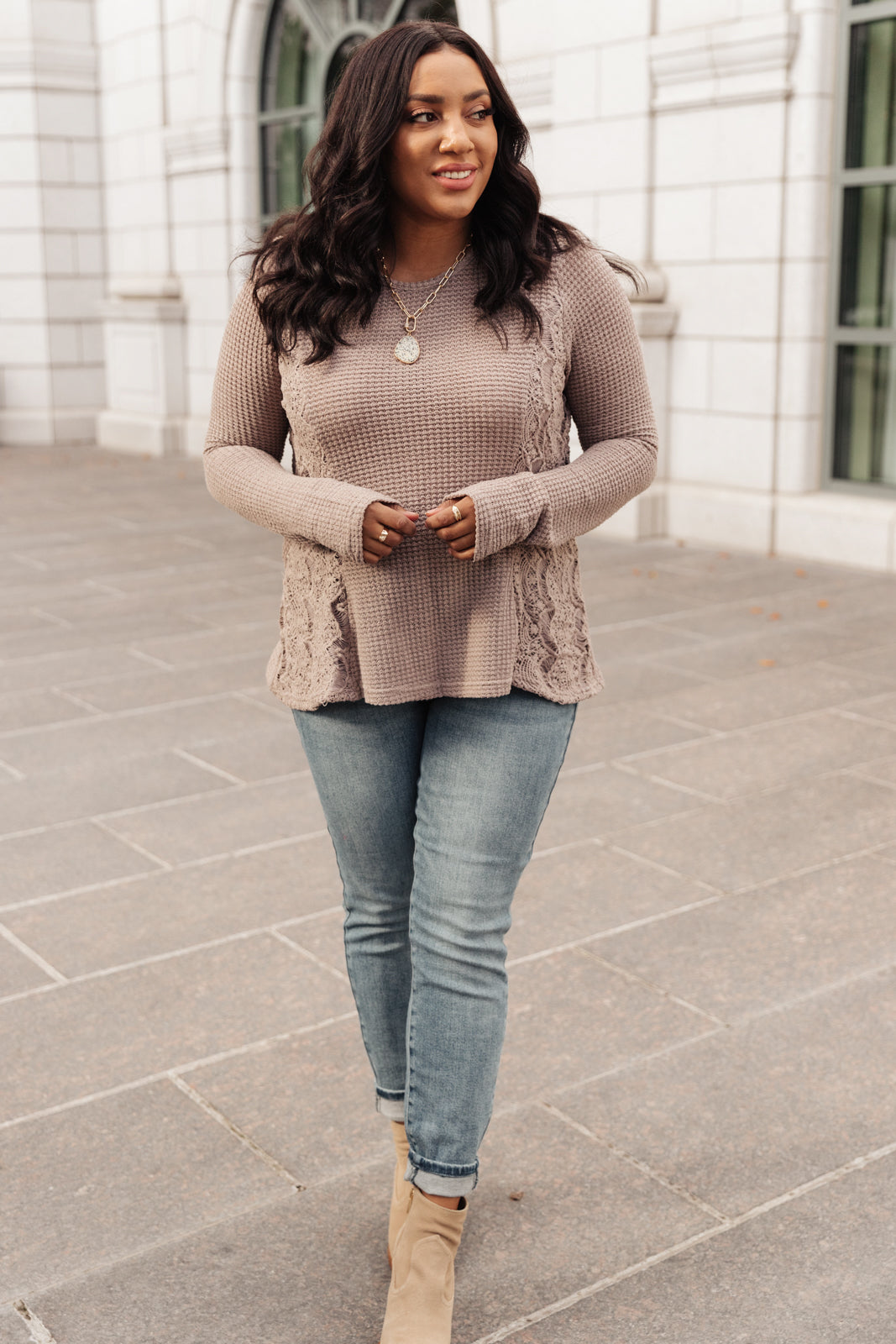 Side Of Art Top in Taupe featuring long sleeves and lace details cascading down the side, showcasing a stylish A-line silhouette.