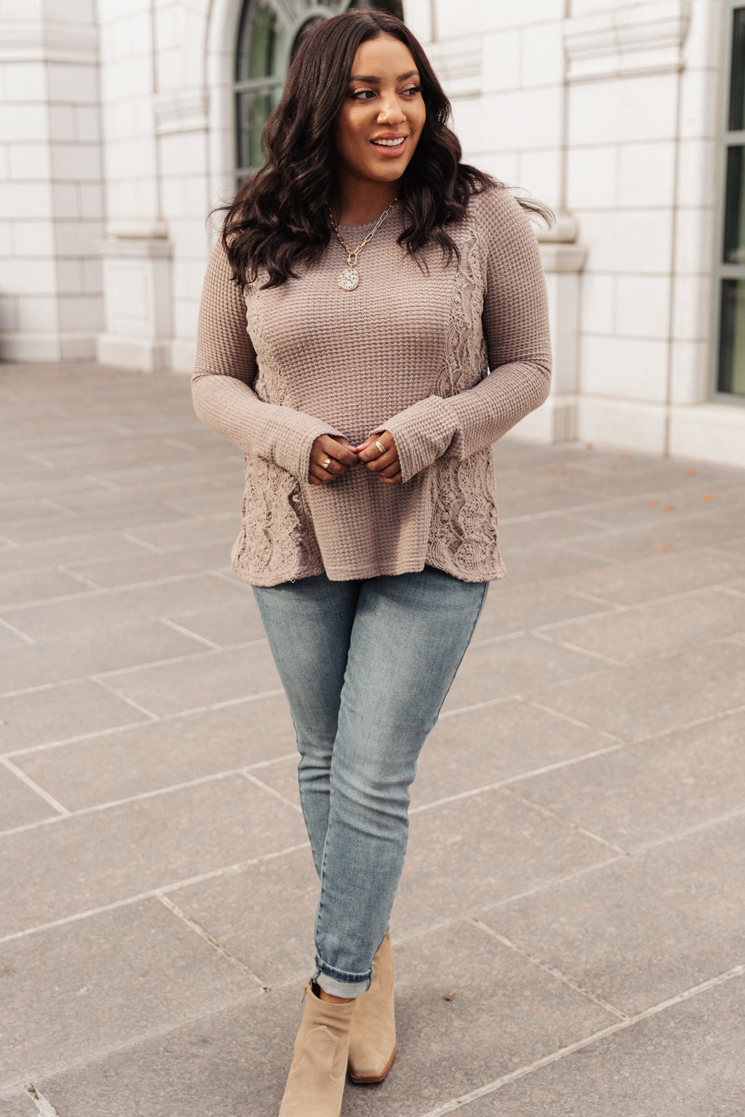 Side Of Art Top in Taupe featuring long sleeves and lace details cascading down the side, showcasing a stylish A-line silhouette.