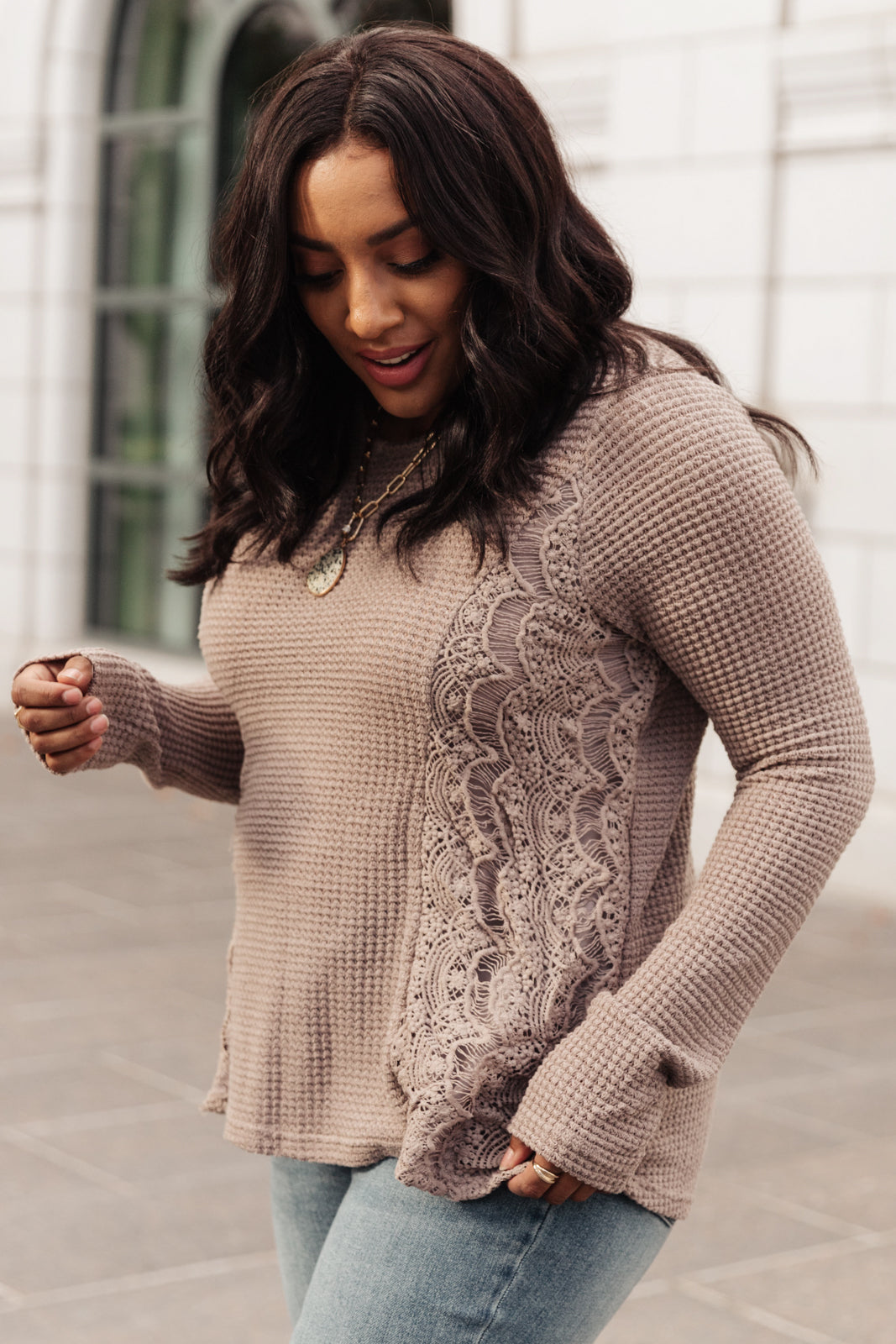 Side Of Art Top in Taupe featuring long sleeves and lace details cascading down the side, showcasing a stylish A-line silhouette.