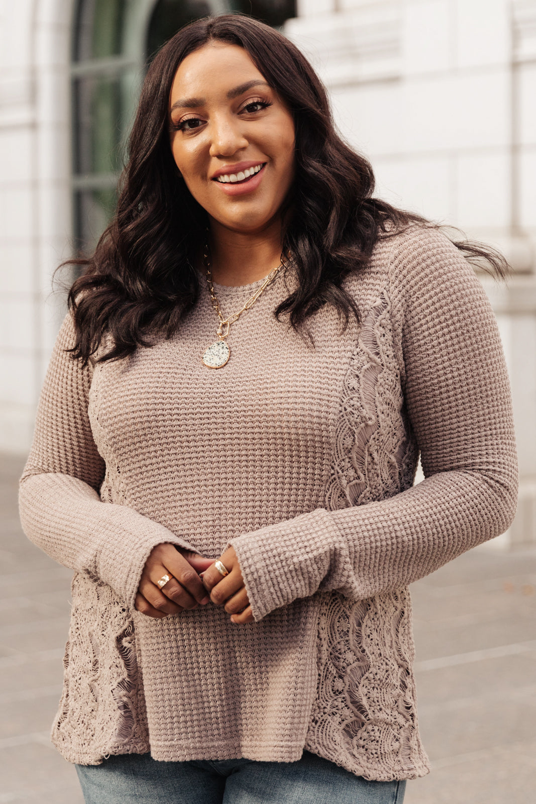 Side Of Art Top in Taupe featuring long sleeves and lace details cascading down the side, showcasing a stylish A-line silhouette.