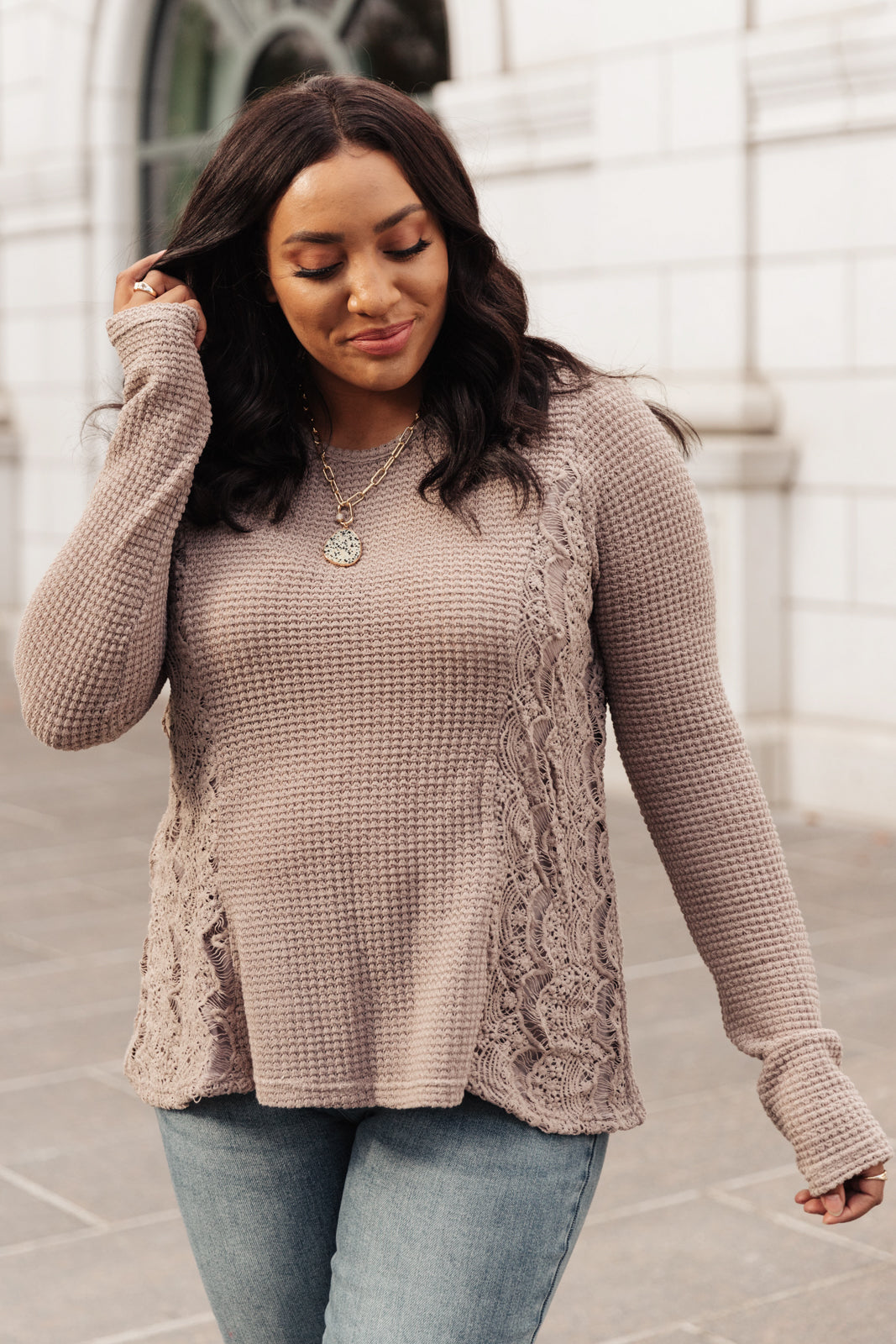 Side Of Art Top in Taupe featuring long sleeves and lace details cascading down the side, showcasing a stylish A-line silhouette.