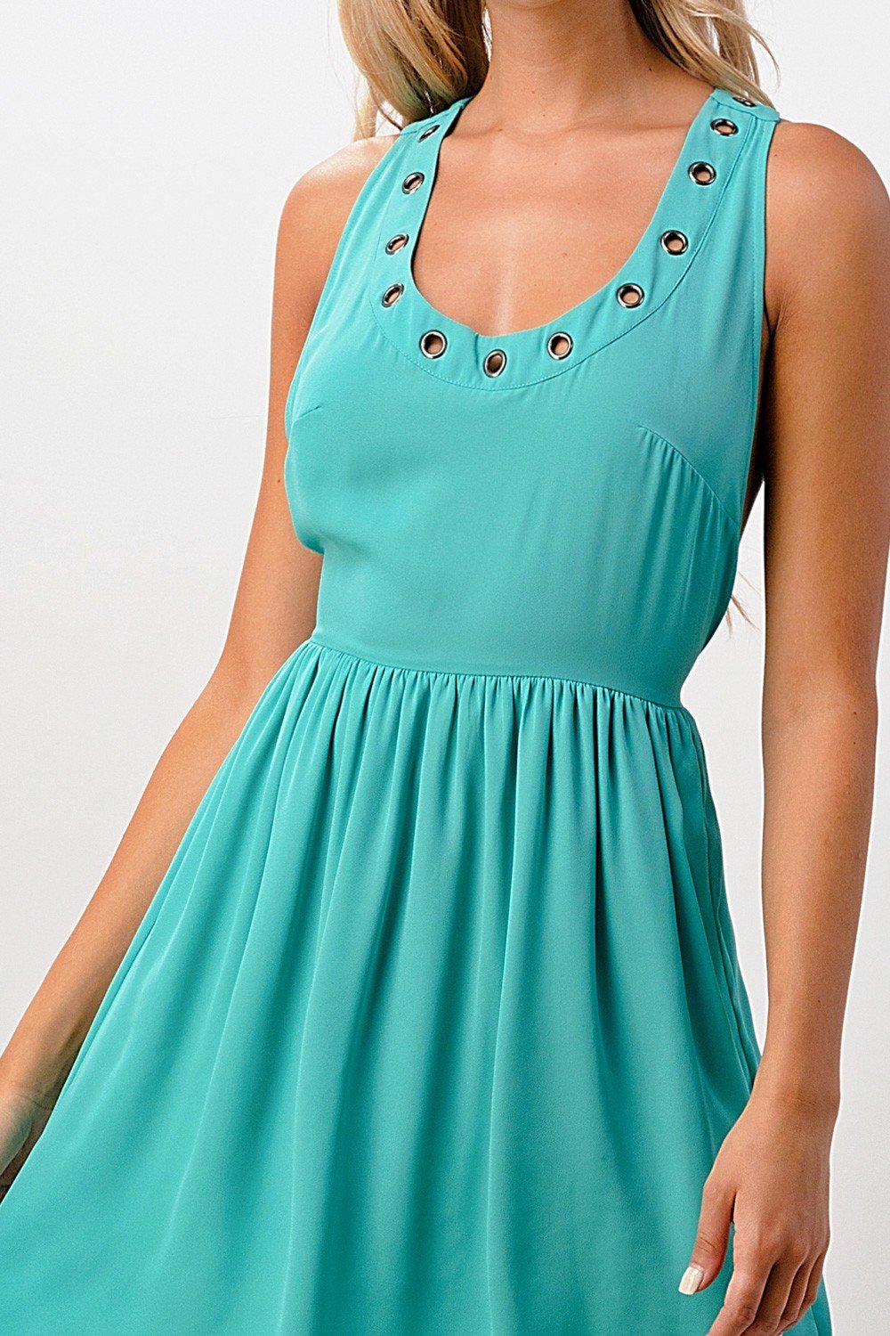 A stylish sleeveless A-line dress featuring grommet details, perfect for various occasions.