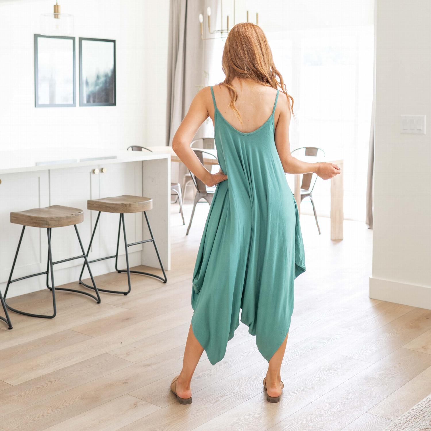 A stylish sleeveless loose fit romper with spaghetti straps, featuring wide legs and a chic design, perfect for summer wear.