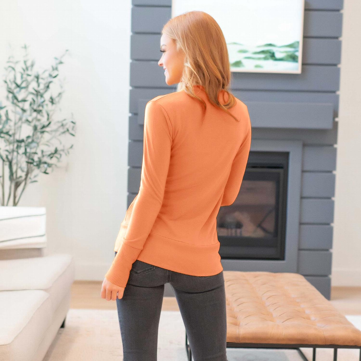 A stylish Snap Button Sweater Cardigan with ribbed texture, featuring button detailing and side pockets, available in various colors.