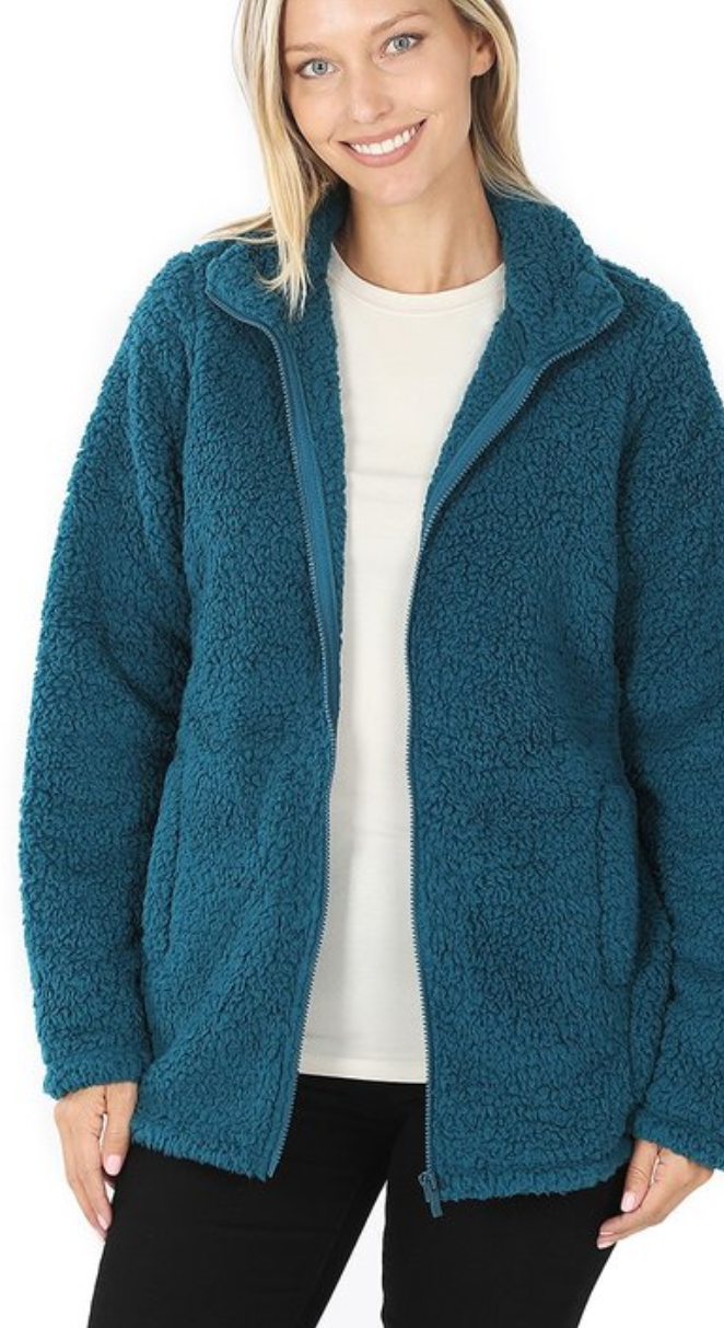 Soft sherpa zip-up jacket in a cozy fabric with side pockets, perfect for chilly weather.