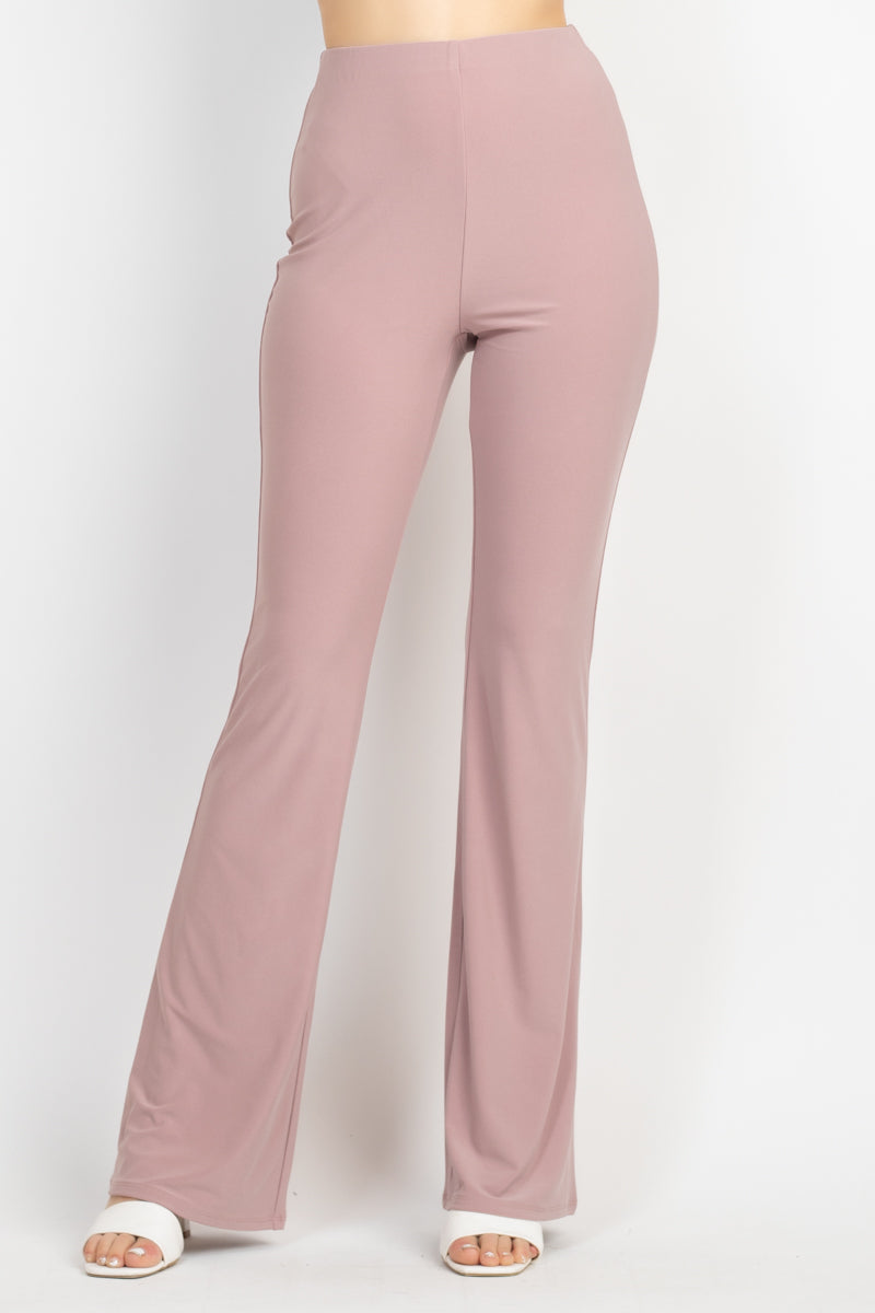 A stylish solid halter top with a drawstring waist and open back, paired with high-rise elastic leggings featuring a bell bottom design.