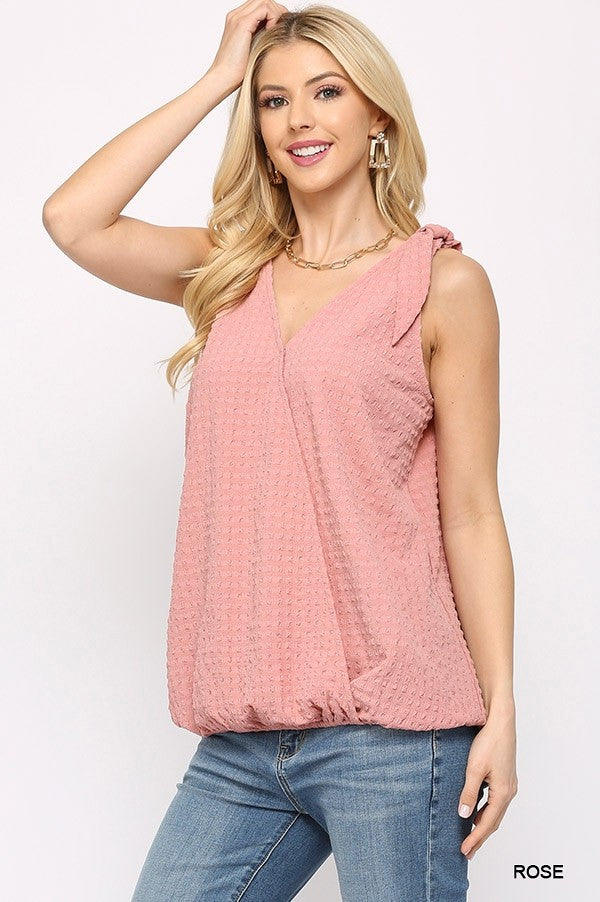 Solid textured sleeveless surplice top with shoulder tie in rose color, showcasing a stylish design and comfortable fit.