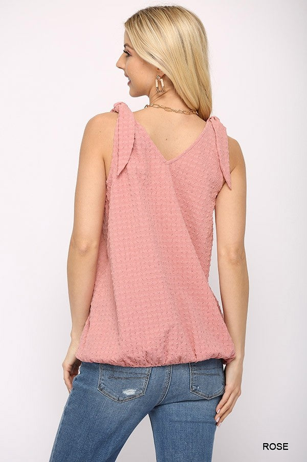Solid textured sleeveless surplice top with shoulder tie in rose color, showcasing a stylish design and comfortable fit.