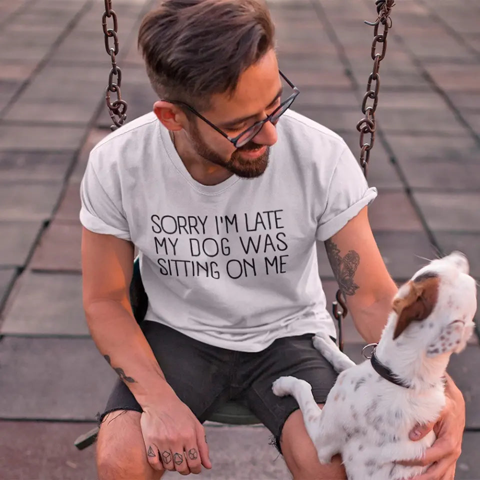 A comfortable unisex T-shirt featuring the phrase 'Sorry I'm Late My Dog Was Sitting On Me', perfect for dog lovers.