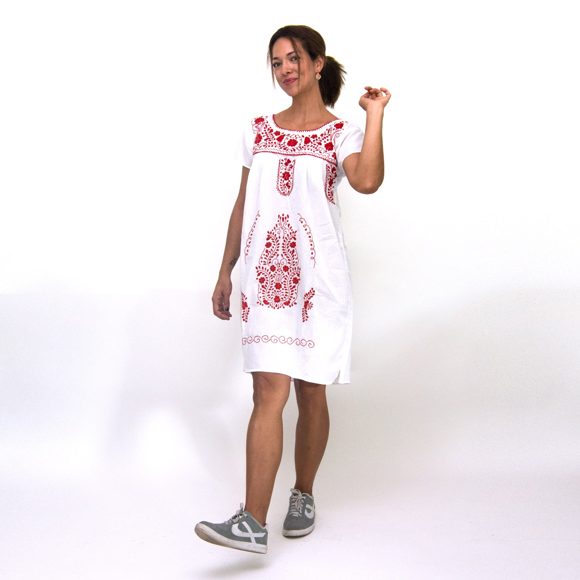 A beautiful Southwestern white dress adorned with vibrant red flowers, showcasing intricate hand embroidery, perfect for bohemian style.