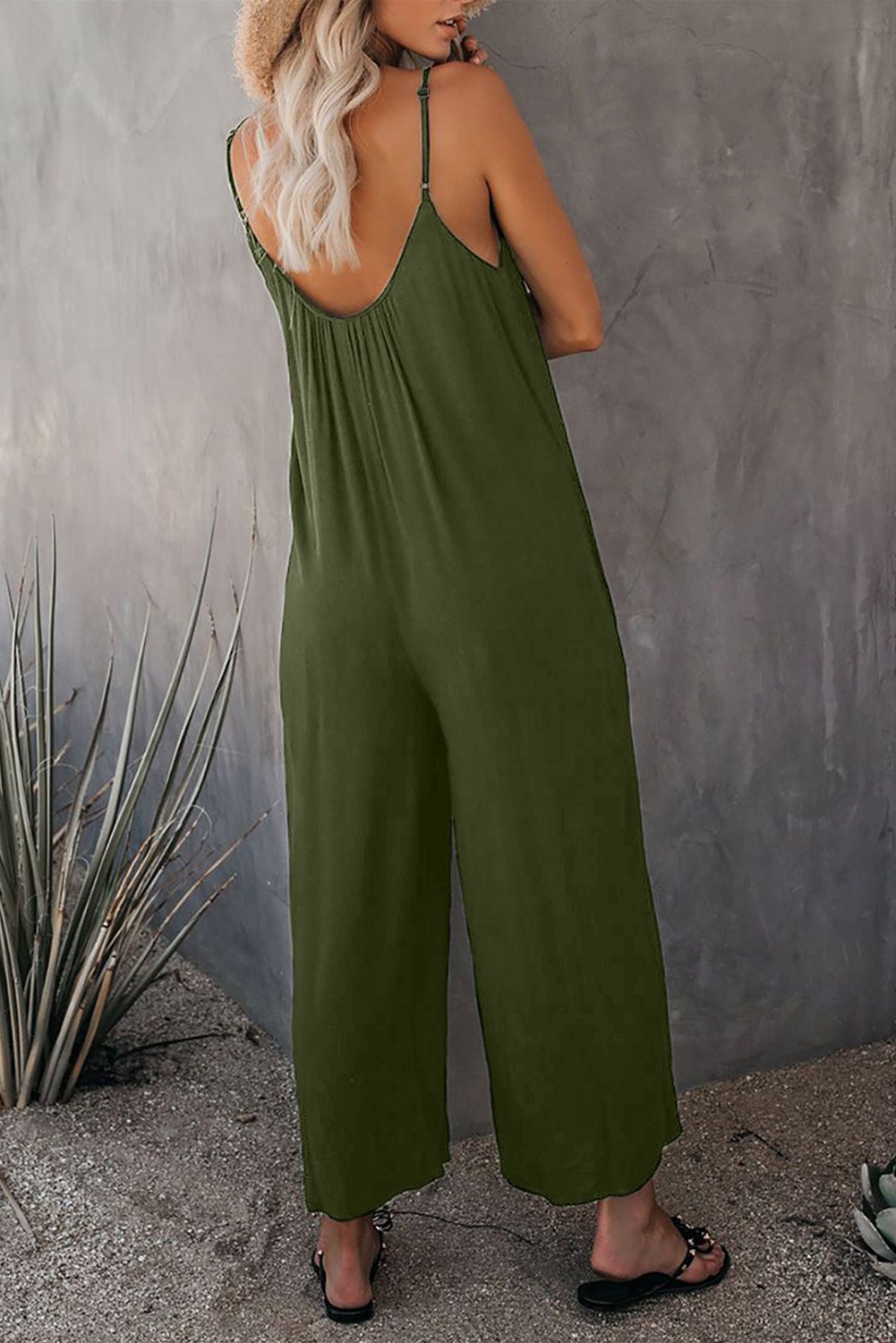 A stylish spaghetti straps wide leg jumpsuit with pockets, perfect for summer wear.