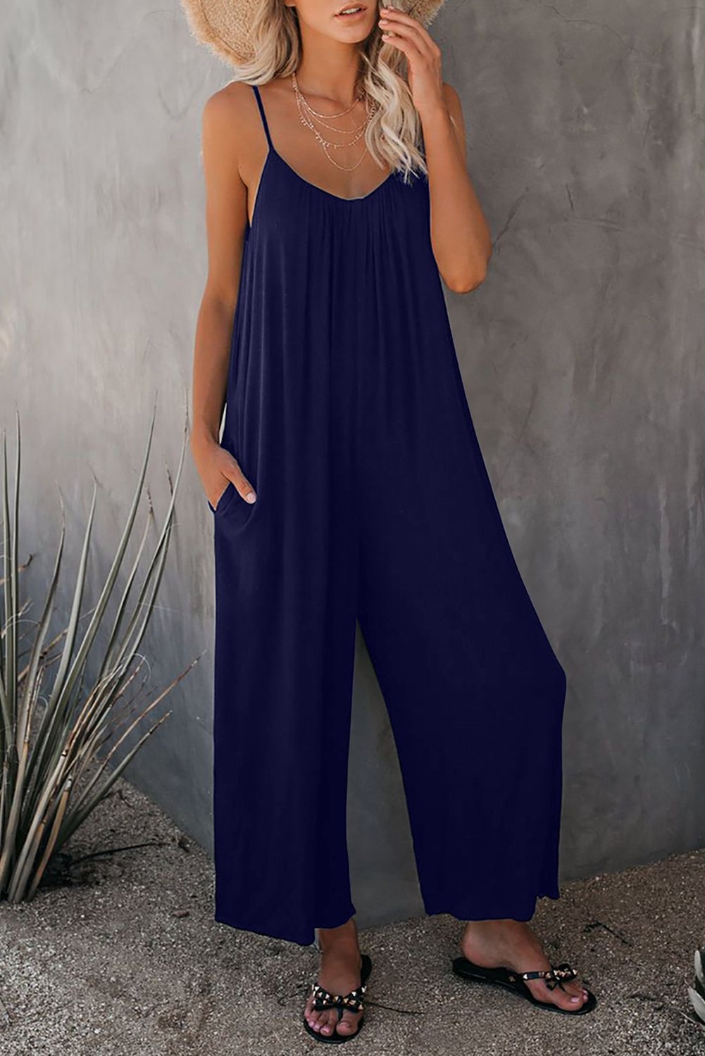 A stylish spaghetti straps wide leg jumpsuit with pockets, perfect for summer wear.