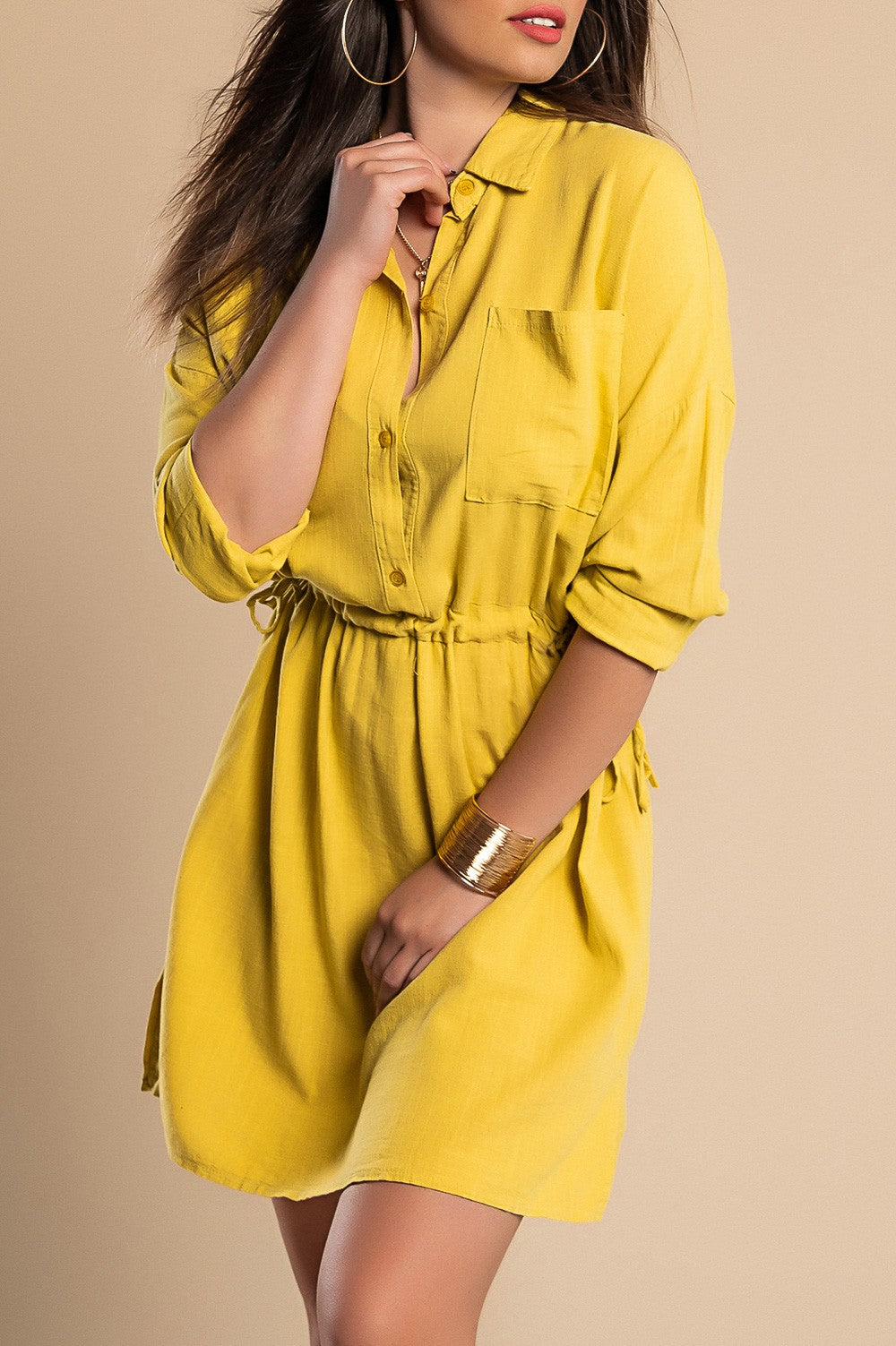 A stylish yellow SPORT MINI DRESS featuring a classic collar, long sleeves, decorative front pocket, and side slits, perfect for casual outings.