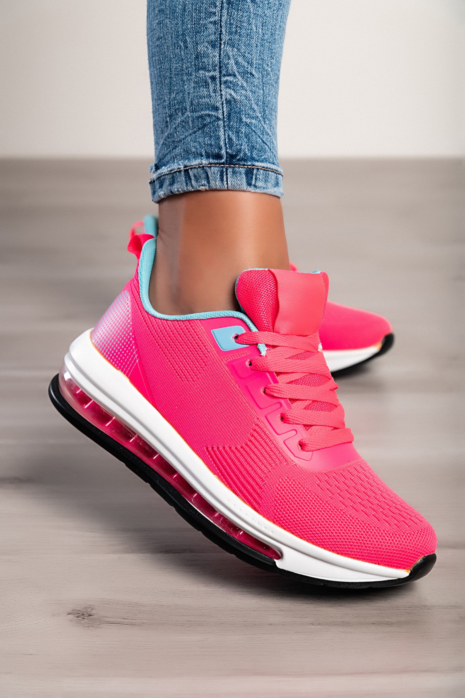 Two-tone sports sneakers in red and blue with a textile upper, round toe, and reinforced heel and toe.