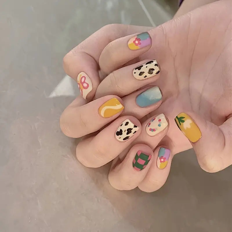 A set of Spring Time Party Nails featuring a glossy finish, oval shape, and unique mix patterns, perfect for stylish nail art.