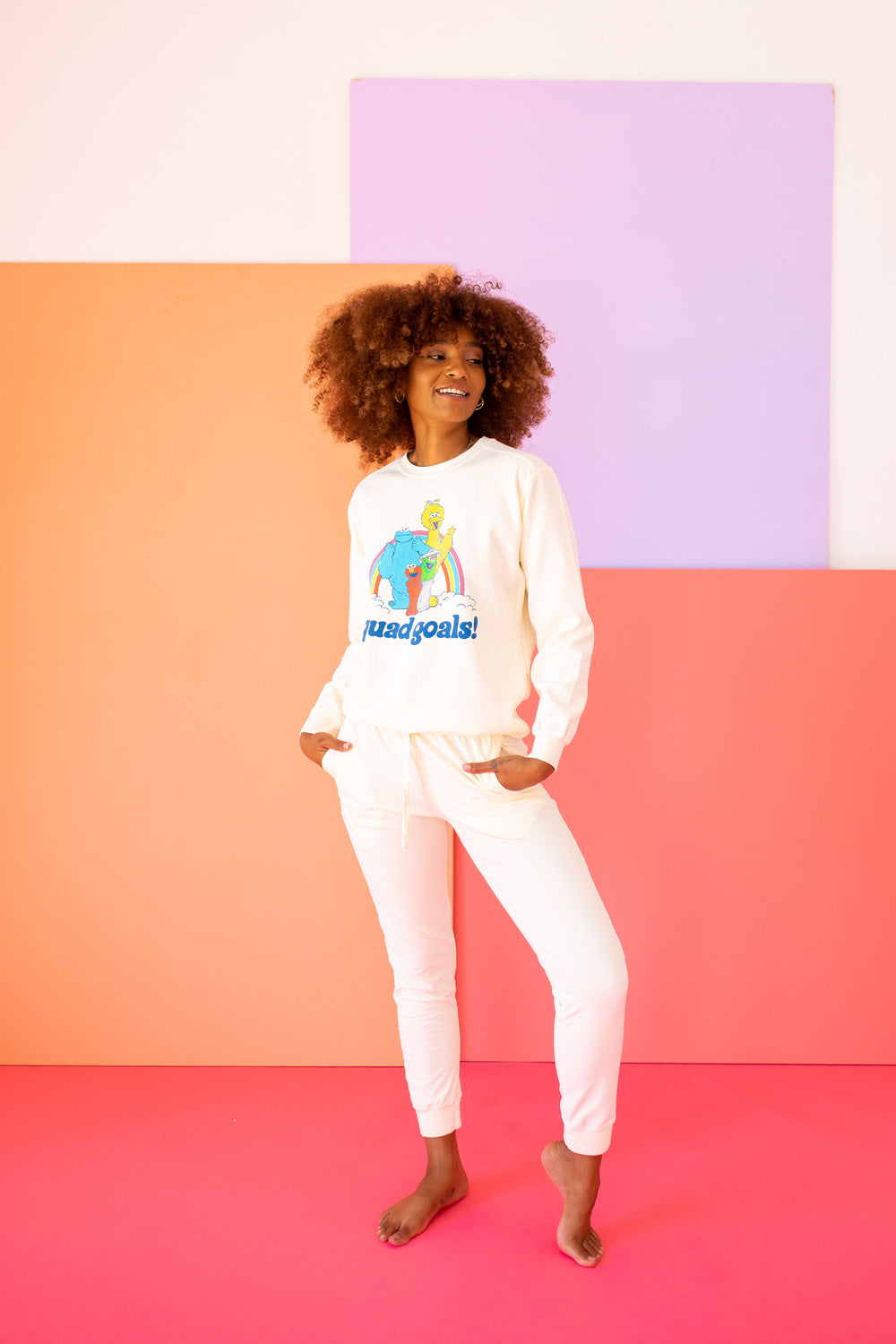 Squad Goals Sesame Sweatshirt featuring Big Bird, Elmo, Cookie Monster, and Oscar the Grouch in vibrant colors on an ivory background.