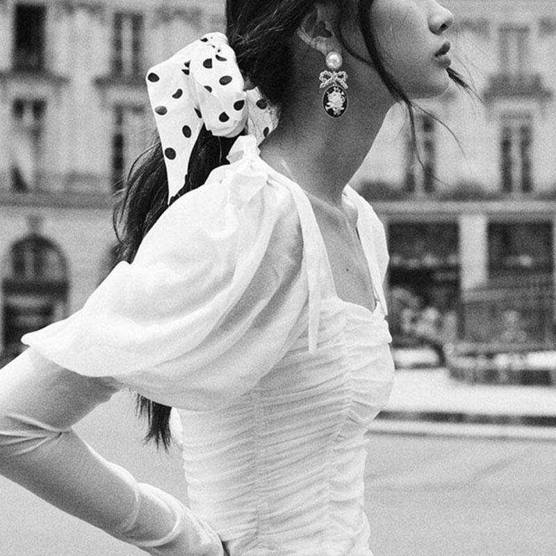 Elegant white blouse with square collar and puff sleeves, featuring a stylish bow, perfect for women's fashion.