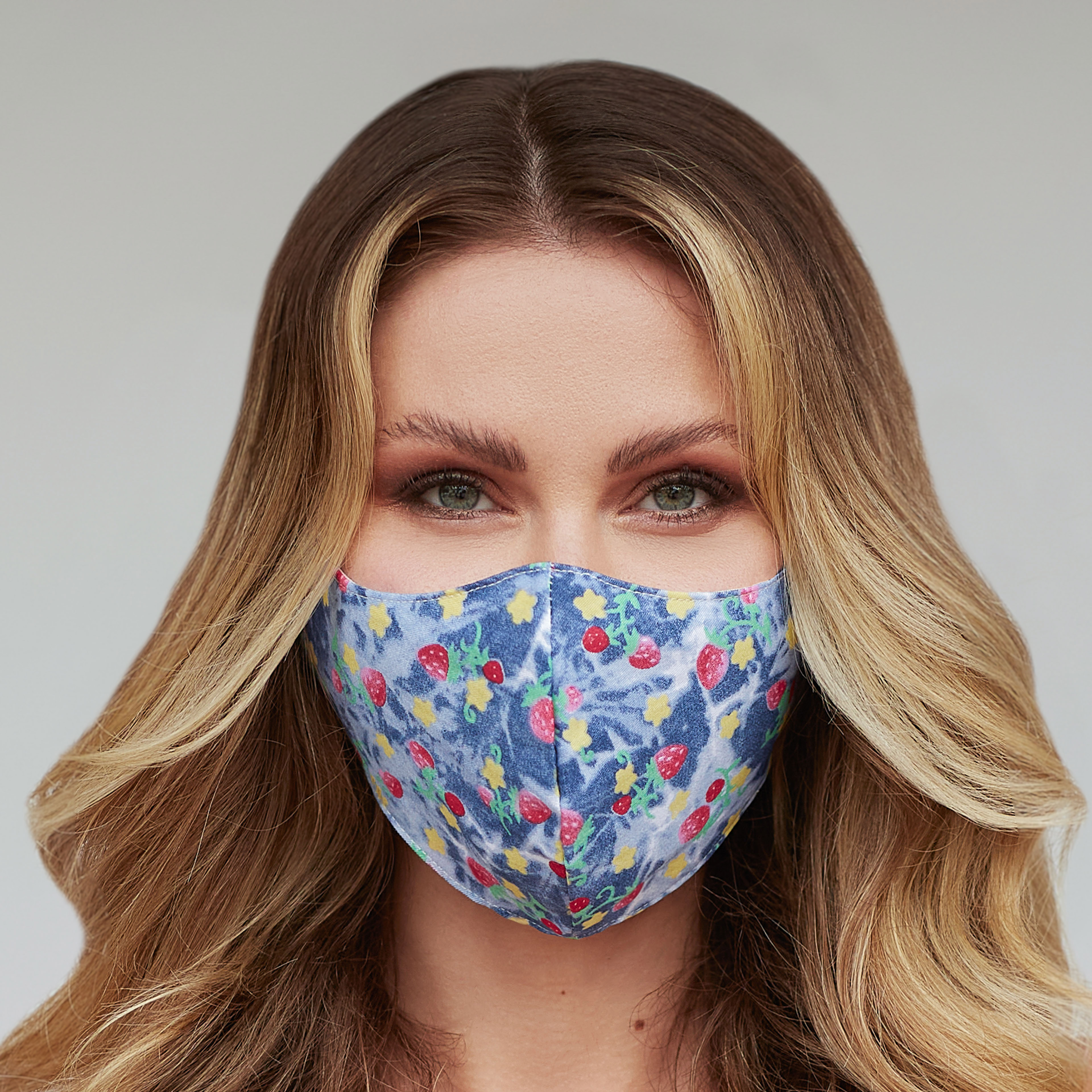 A vibrant strawberries patterned face mask, showcasing a unique design perfect for personal expression and protection.
