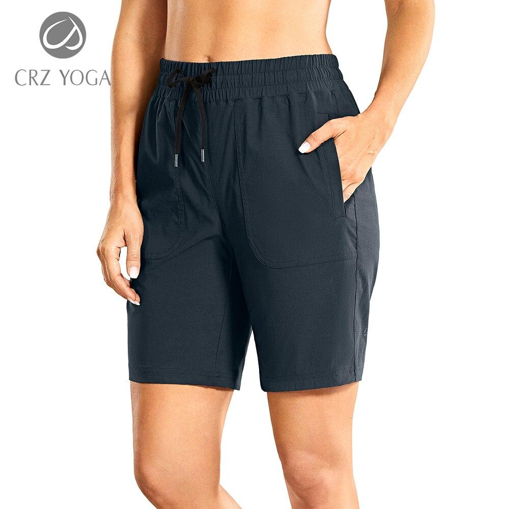 A pair of women's stretch quick-dry athletic shorts in solid color, featuring side pockets, designed for workouts and casual wear.