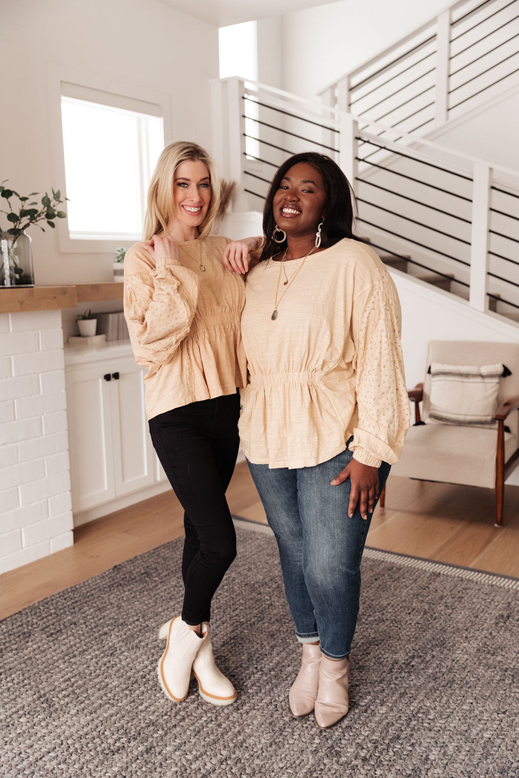 A stylish peach floral top featuring balloon dolman sleeves and an elastic waistband, perfect for a feminine look.