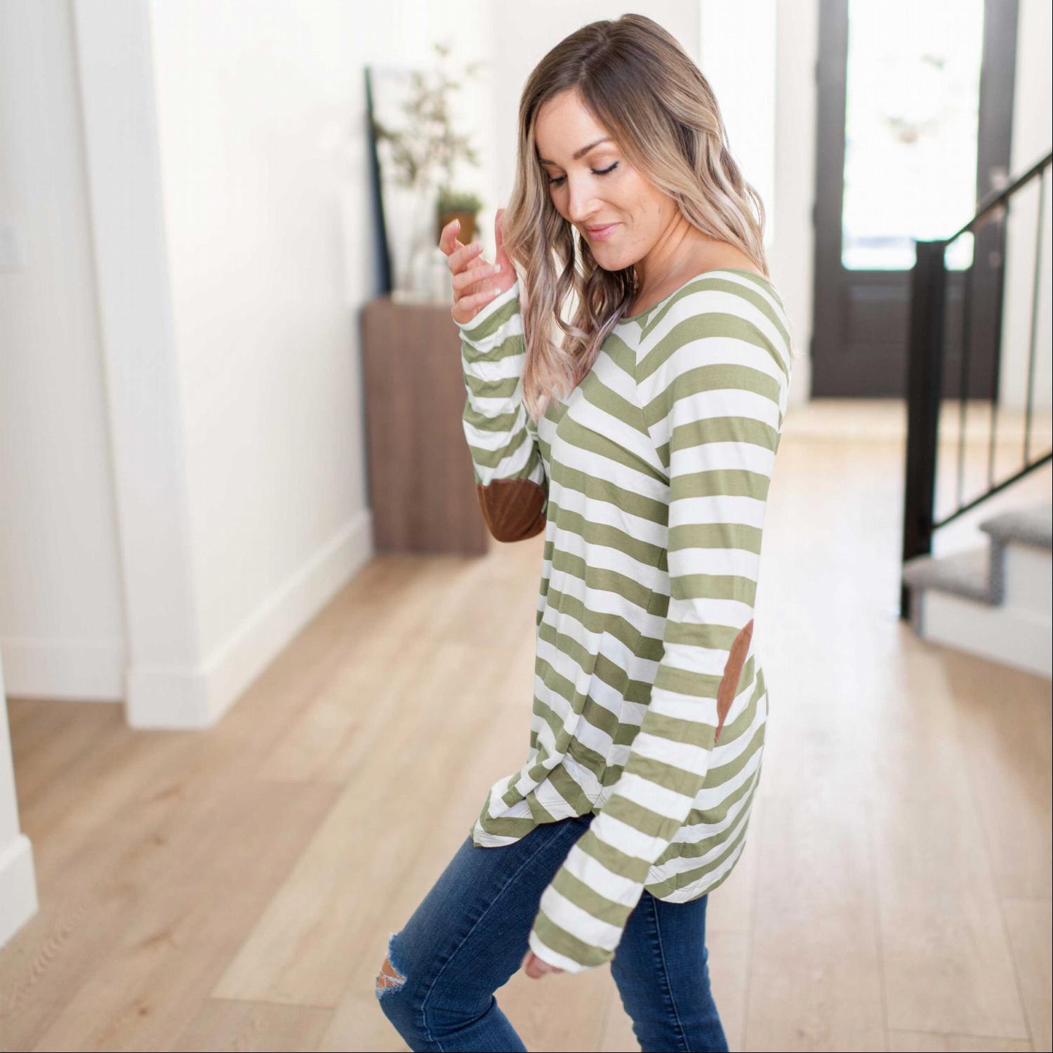 Striped long sleeve boat neck top featuring elbow patches and a dolphin hem, made from a soft cotton-modal blend fabric.