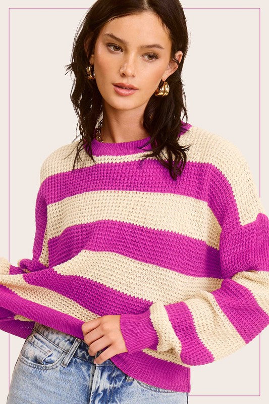 A stylish striped round neck loose fit sweater in a casual design, featuring long sleeves and a comfortable fit, perfect for everyday wear.