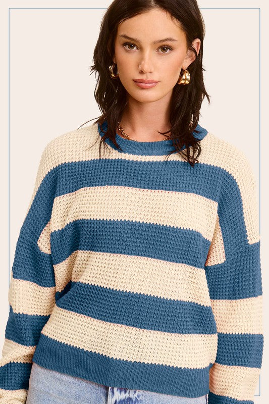 A stylish striped round neck loose fit sweater in a casual design, featuring long sleeves and a comfortable fit, perfect for everyday wear.