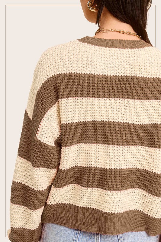 A stylish striped round neck loose fit sweater in a casual design, featuring long sleeves and a comfortable fit, perfect for everyday wear.