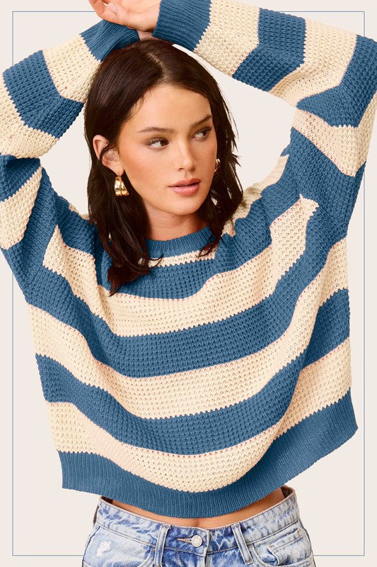 A stylish striped round neck loose fit sweater in a casual design, featuring long sleeves and a comfortable fit, perfect for everyday wear.
