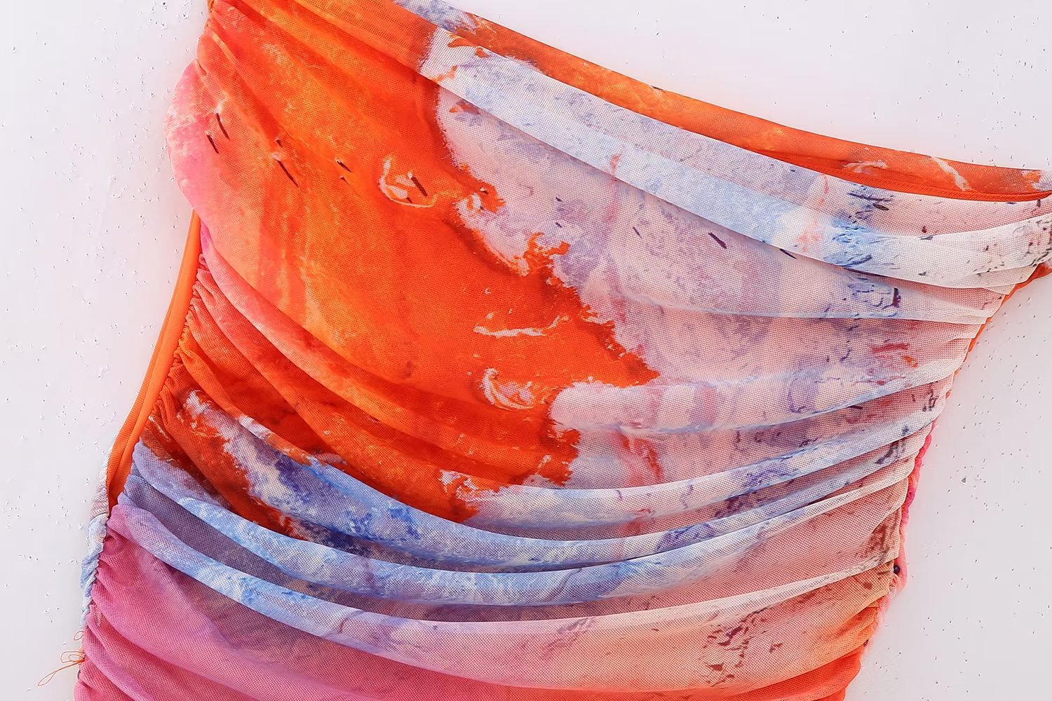 A stylish Summer Pleated Tulle Dress for women featuring an asymmetrical neckline and pleated design, perfect for beach outings.