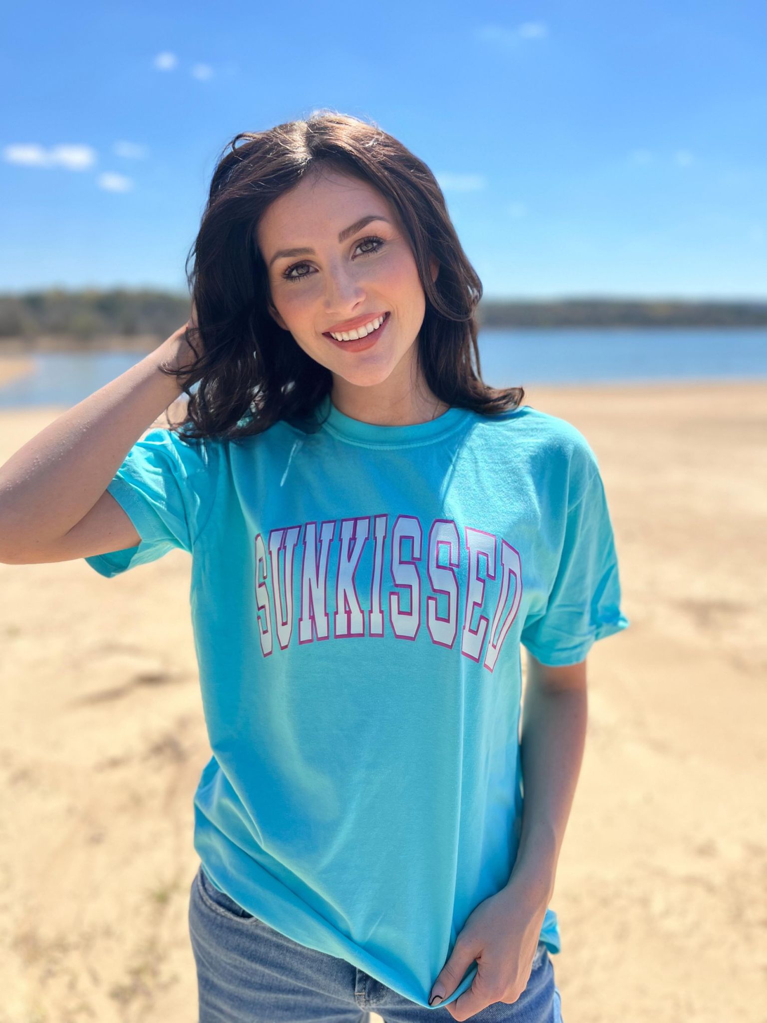 A vibrant Lagoon Blue Sunkissed Arch Tee made from 100% cotton, featuring a stylish DTF printed design, perfect for summer wear.