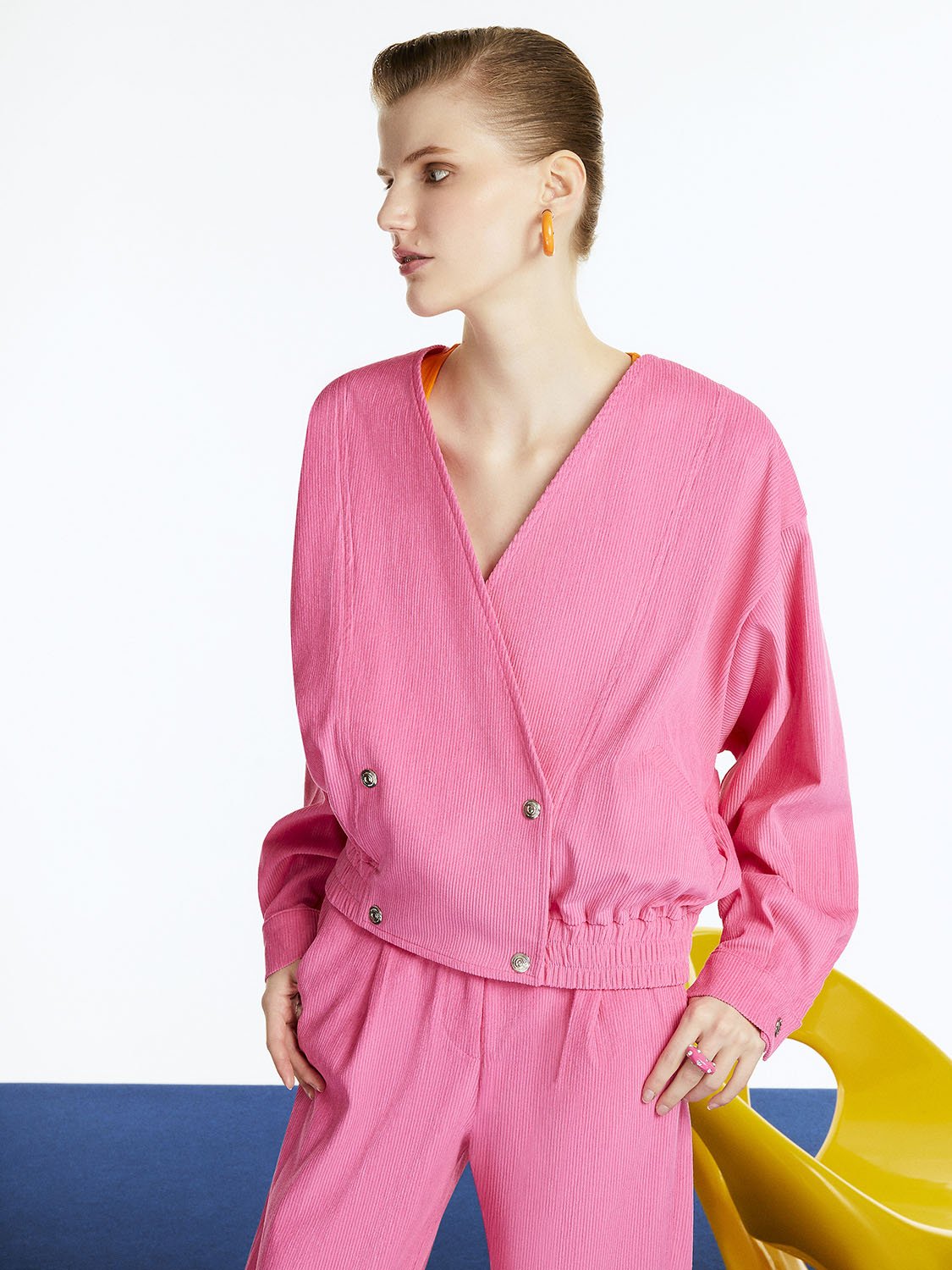 Surplice Corduroy Jacket featuring vibrant orange, pink, and blue colors with a stylish collar and snap button closure.