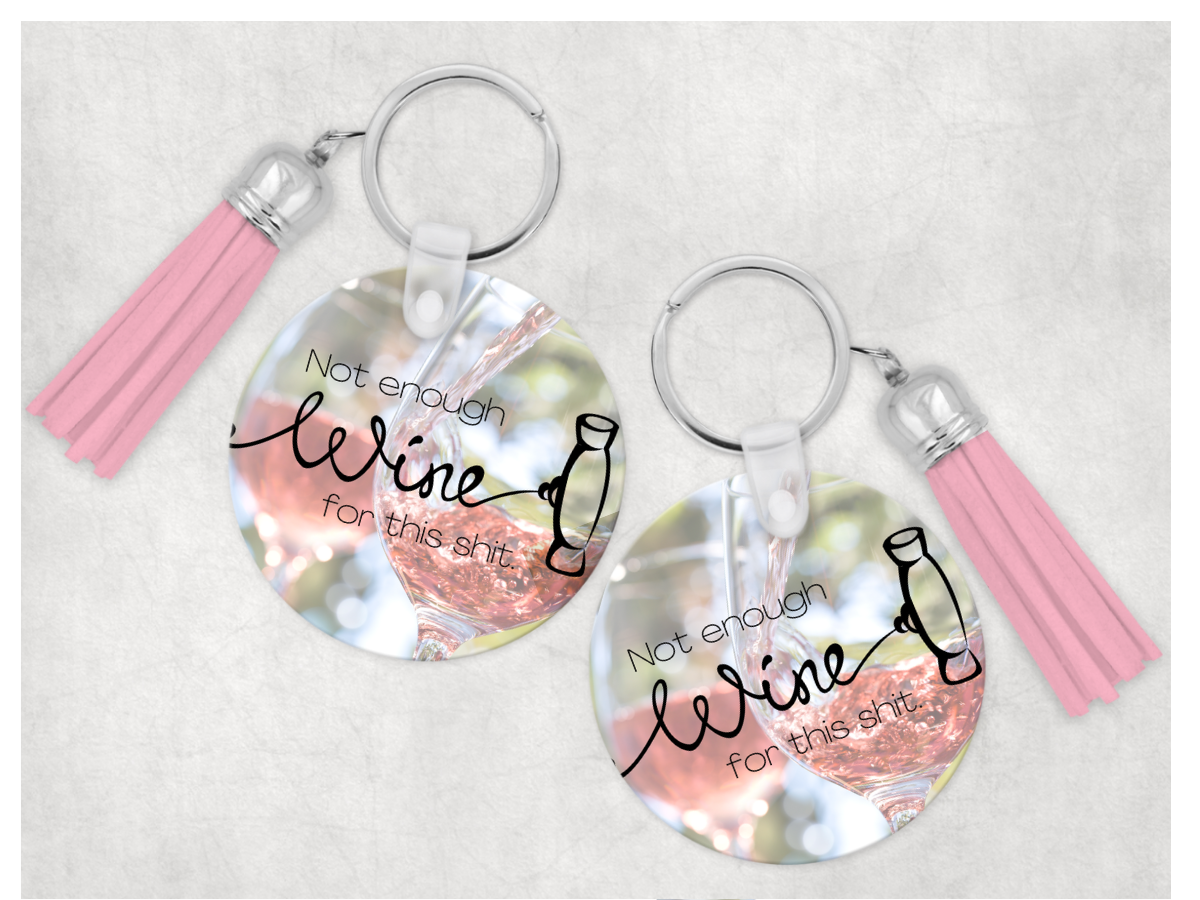 A humorous keychain featuring the phrase 'Not Enough Wine For This Shit' with a colorful tassel.
