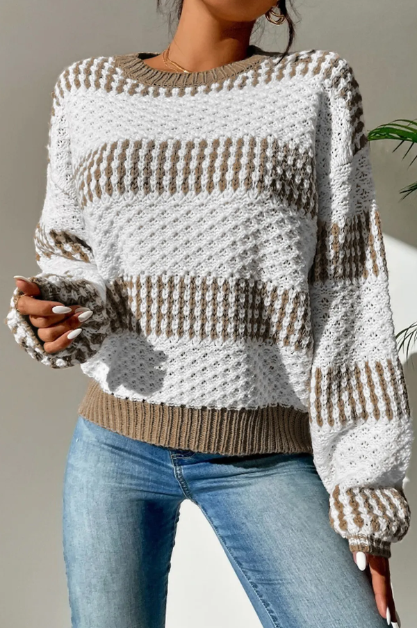 A cozy two-tone multicolor sweater featuring long sleeves and a round neckline, made from soft acrylic knitwear.