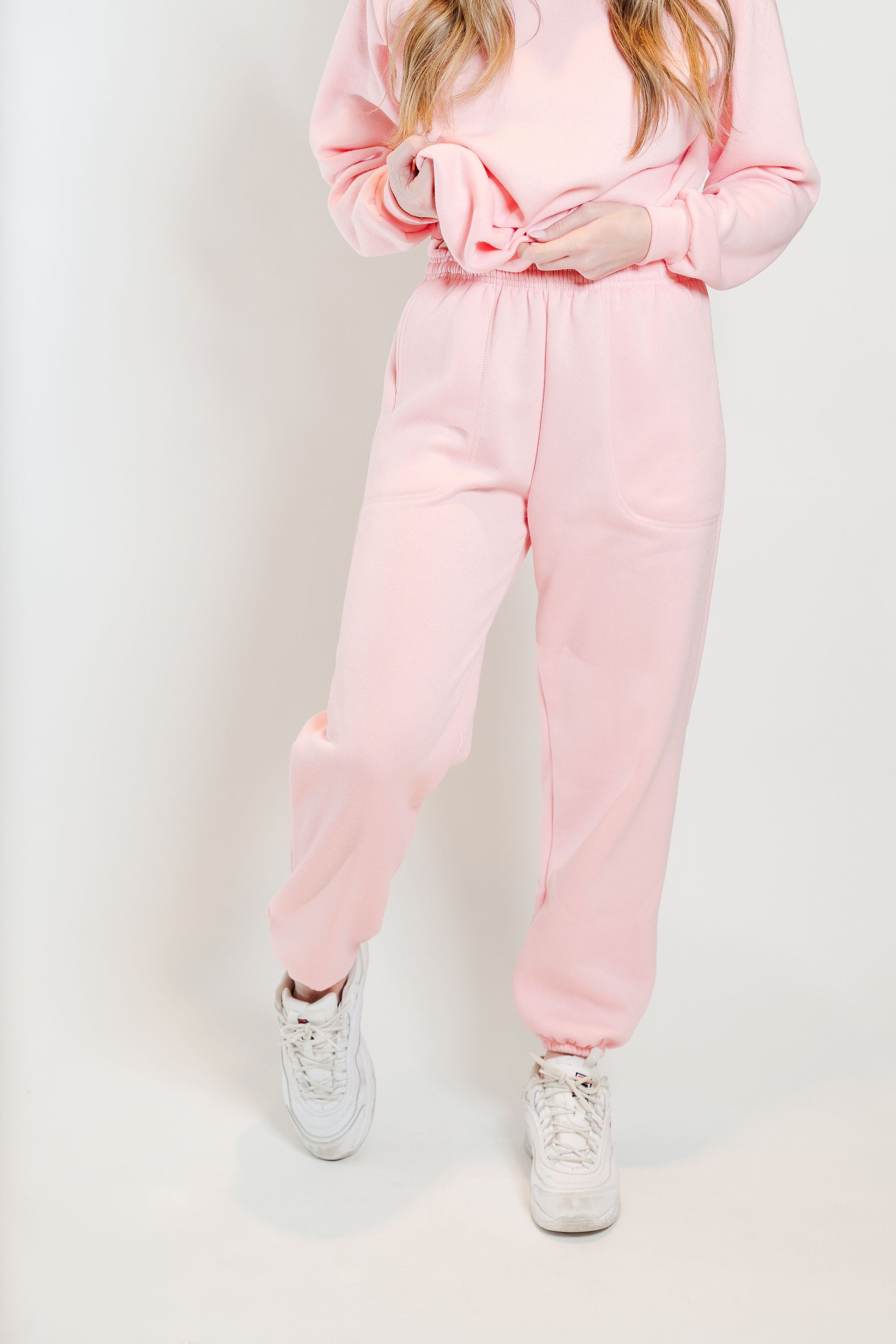 A pair of soft pink sweatpants designed for comfort and style, featuring an elastic waistband and a cozy interior.