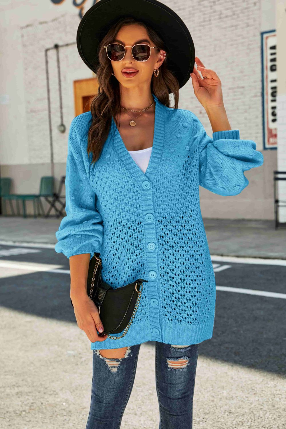 A stylish Swiss Dot Openwork Button Front Longline Cardigan in a studio setting, showcasing its unique openwork design and casual elegance.