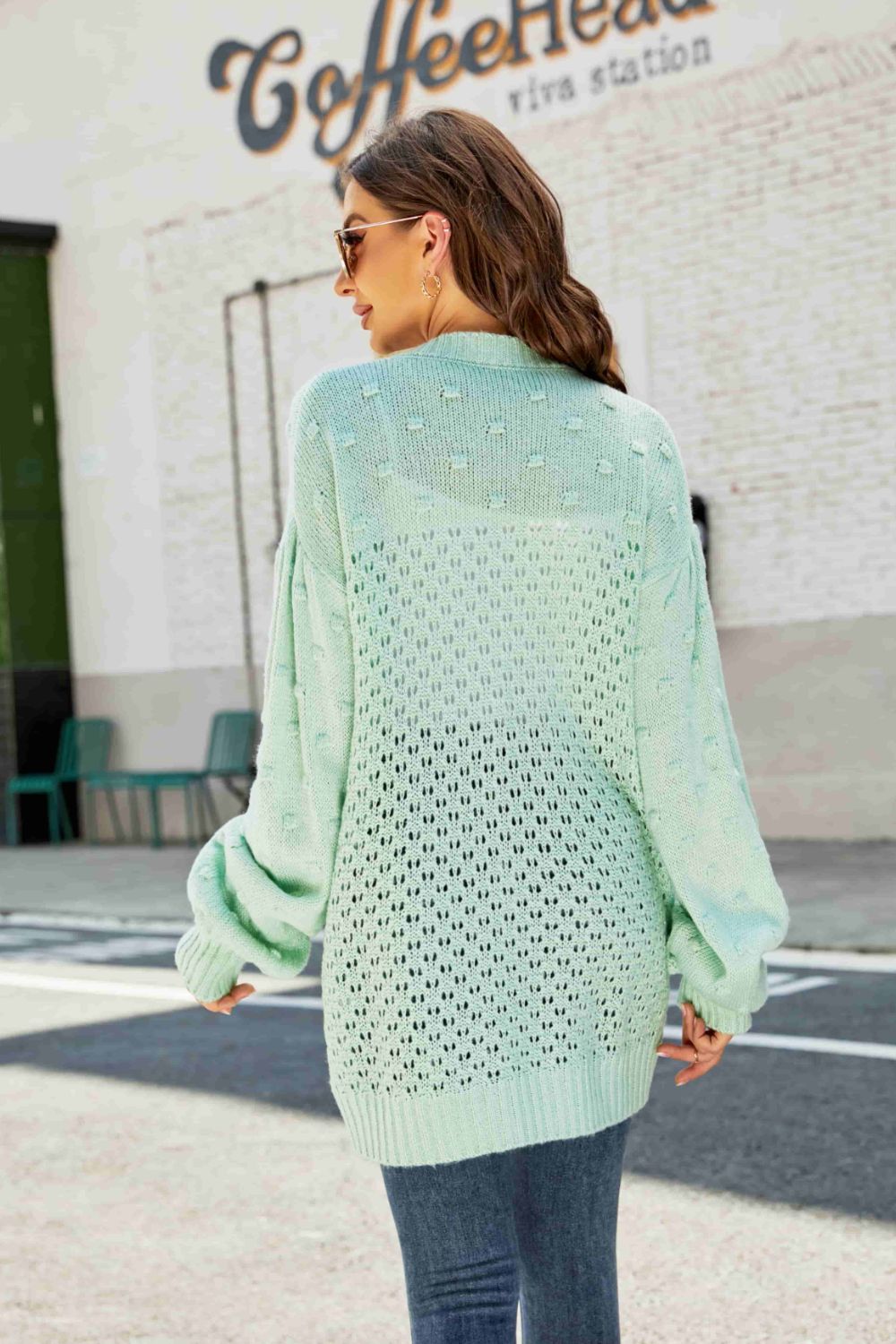 A stylish Swiss Dot Openwork Button Front Longline Cardigan in a studio setting, showcasing its unique openwork design and casual elegance.