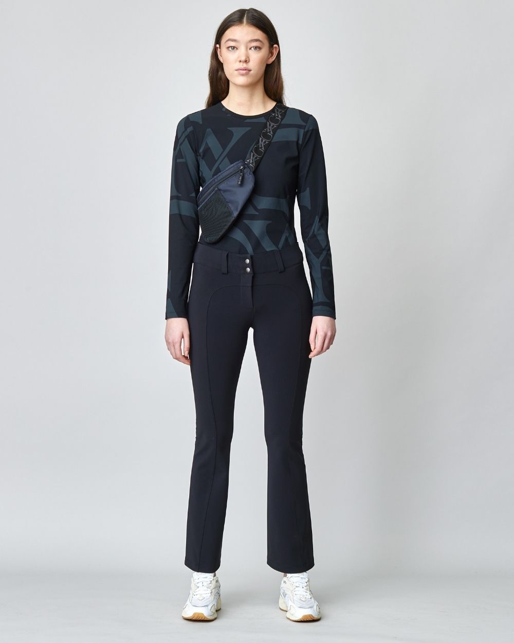 A pair of black tailored flared trousers made from lightweight Italian jersey, featuring a high waist and hook and eye closure.