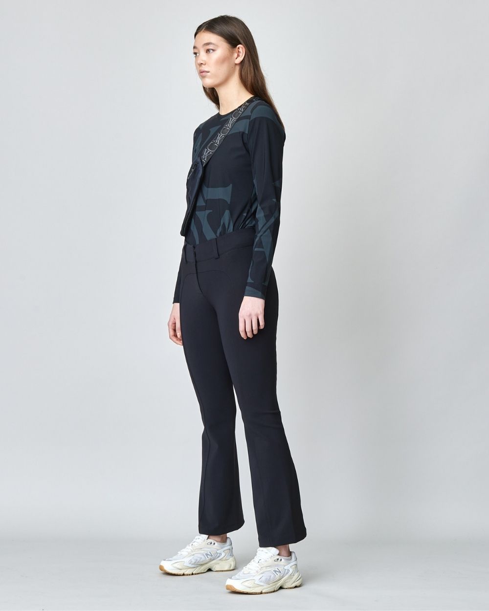 A pair of black tailored flared trousers made from lightweight Italian jersey, featuring a high waist and hook and eye closure.