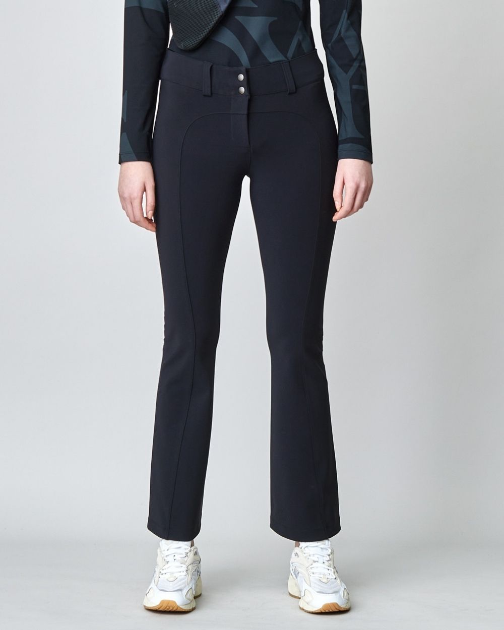 A pair of black tailored flared trousers made from lightweight Italian jersey, featuring a high waist and hook and eye closure.
