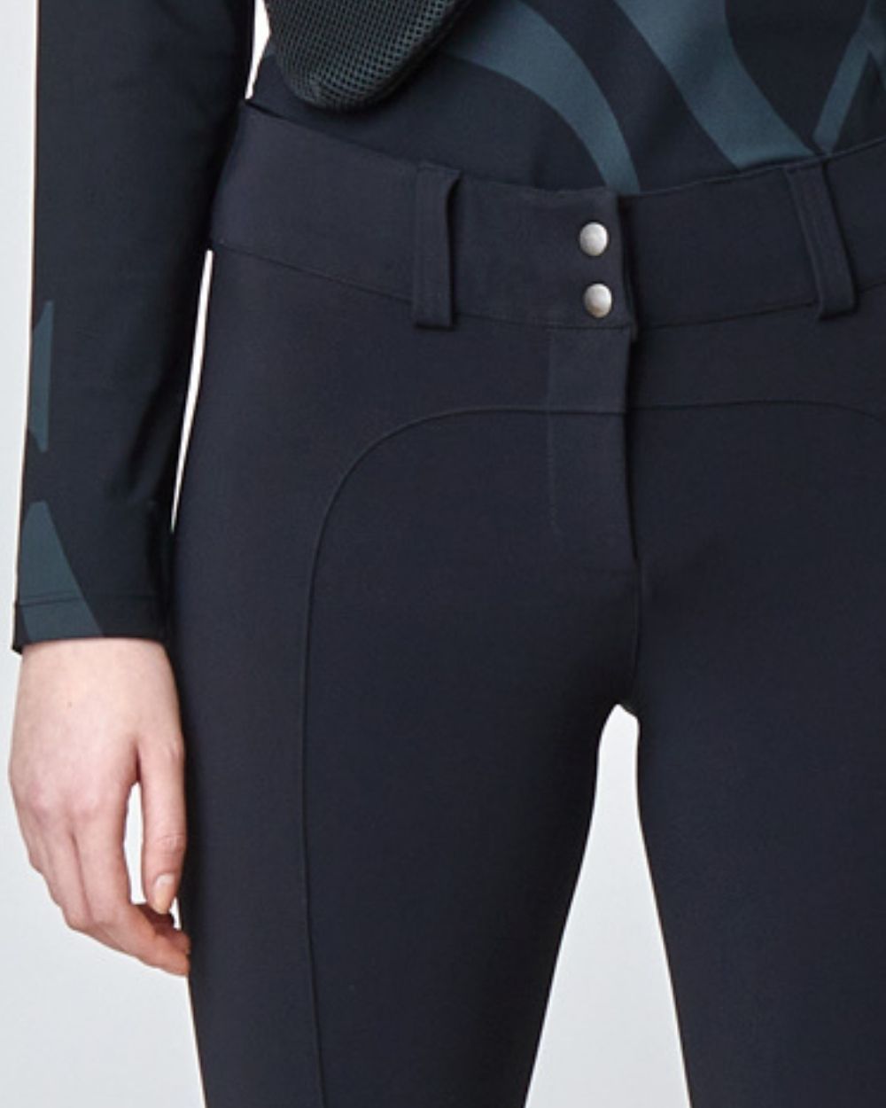 A pair of black tailored flared trousers made from lightweight Italian jersey, featuring a high waist and hook and eye closure.
