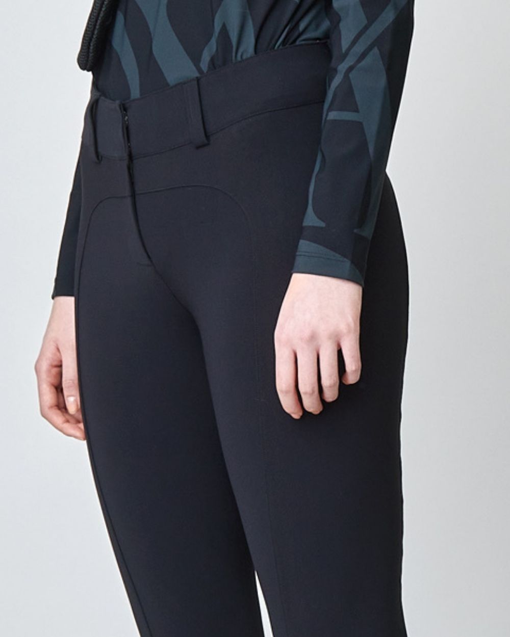 A pair of black tailored flared trousers made from lightweight Italian jersey, featuring a high waist and hook and eye closure.