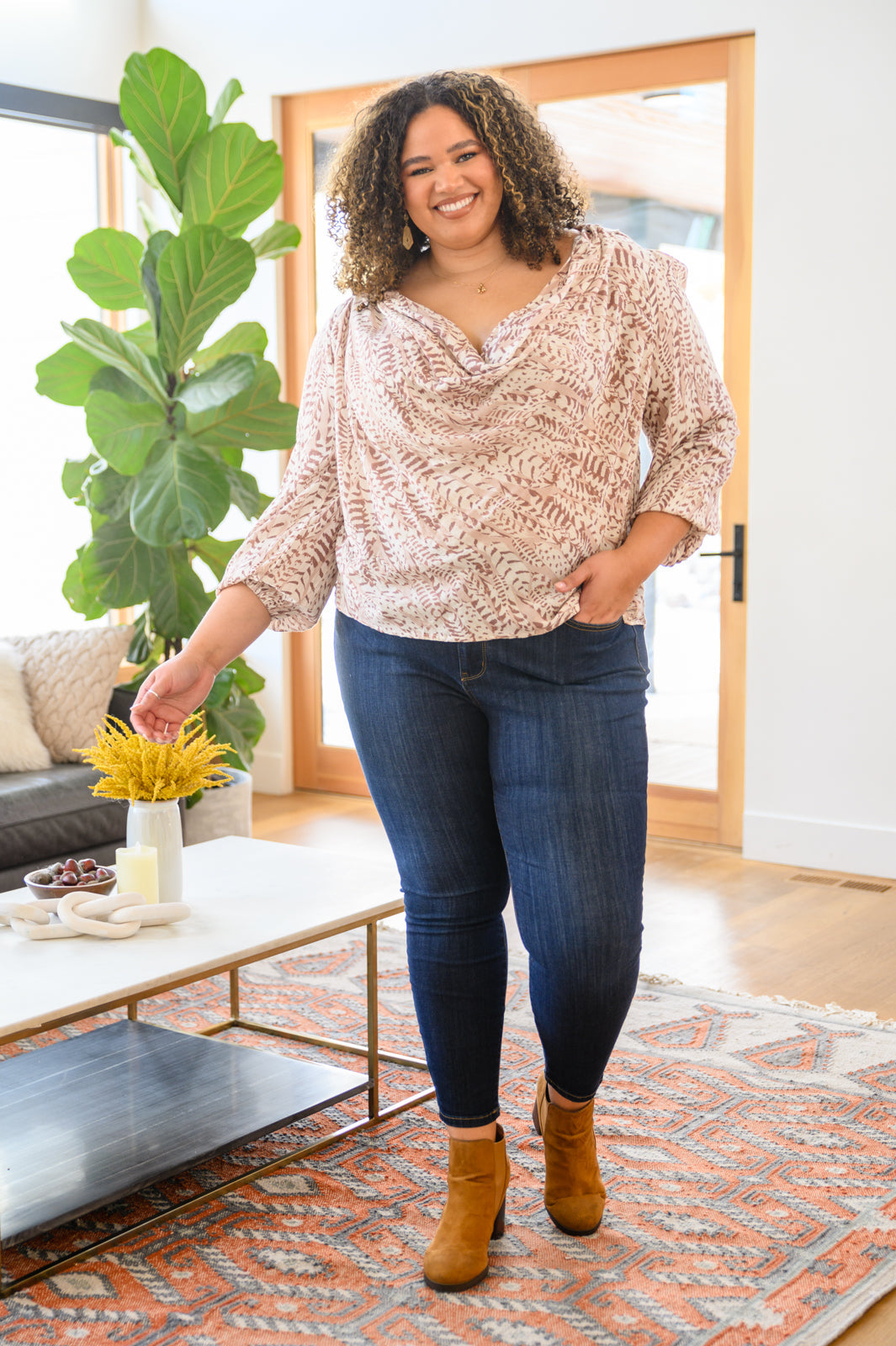 Take Flight Cowl Neck Top featuring a deep cowl neckline, soft bishop sleeves, and an abstract print with gold sparkle details.